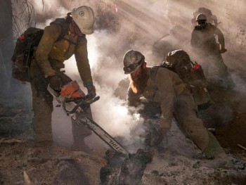Hotshot firefighters using chainsaws and mopping up