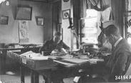 Historic photo of a ranger sitting at a desk