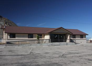 Front of the Austin-Tonopah Ranger District's Tonopah Office that is cream with dark brown trim and roof.