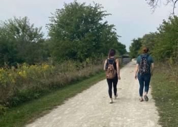 Hiking Header - Two People Walking Along Trail