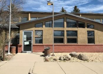 The front entrance to an office with the American Flag out front.