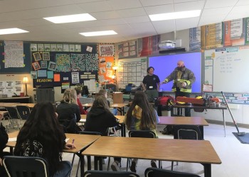 Firefighters Jesse Penland and Brenna Jones tell students about firefighting