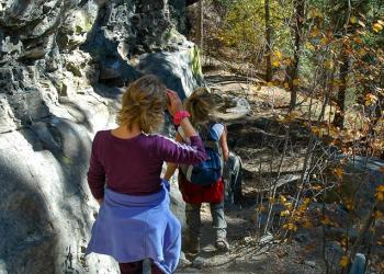 Two hikers on a trail in the Fall.