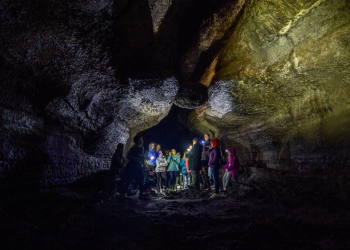 A group of cavers look in a cave