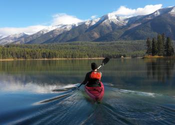 A kayaker paddling on a river