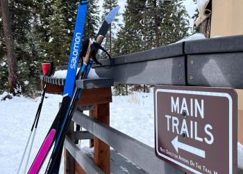 Image of skis and the main trail sign the Seeley Creek Nordic Ski Trails.