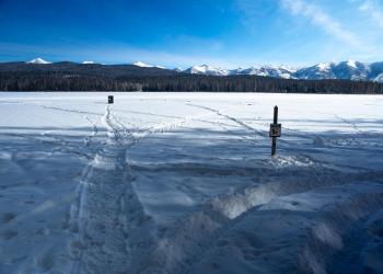 Photo of an ice fishing access on Seeley Lake in wintertime, Lolo National Forest, Montana.