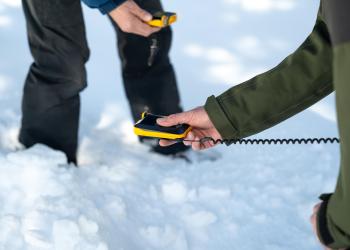 Photo of two people doing avalanche training on the Lolo National Forest, Montana. 