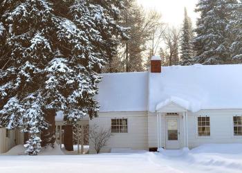 Image of the East Cottage at Savenac in the wintertime, Lolo National Forest, Montana.