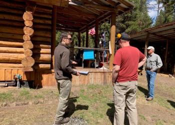Men doing an assessment around a house