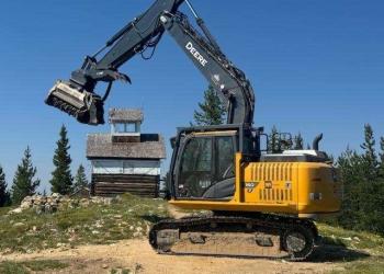 a piece of heavy machinery working at a lookout tower
