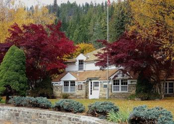 photo of a lovely building behind autumn trees