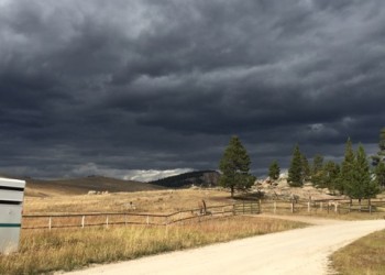 Image of dark storm clouds over a mountain meadow