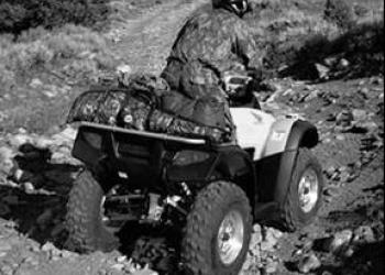 An all-terrain vehicle navigates a steep trail