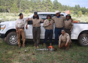 Six members of Native American Crew in front of truck