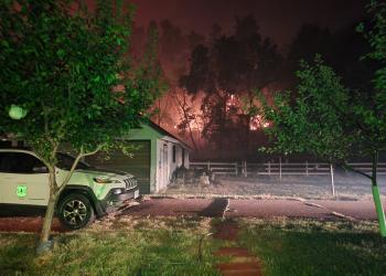 Fire backs down a hillside towards employee housing.