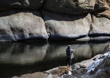 a man fishes in Eleven Mile Canyon Recreation Area