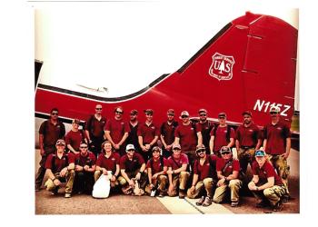 Fire crew in front of retardant plane