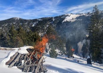 Pile burn in snowy mountains