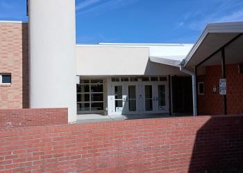 The facade of a mostly brick building.