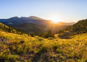 sun setting over a trail