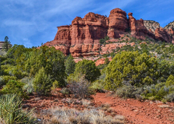 Famous Red Rock towering in front of a blue sky