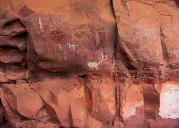 Pictographs are visible on a red rock wall