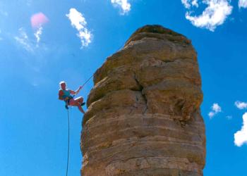 A rock climber ascends a hoodoo in the Santa Catalina Ranger District