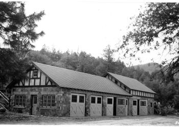 Rock sided barn with several bays.