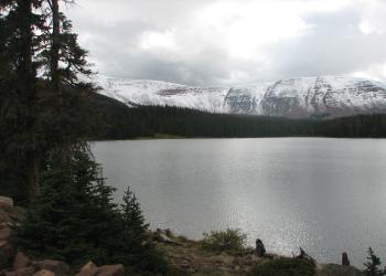 View of Spirit Lake - photo of lake with pine trees and snow covered mountains