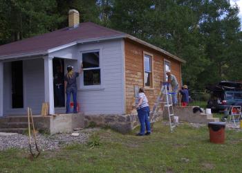 Beaver Ranger District employees and volunteers from the Passport In Time program work together to give the Big Flat Guard Station a new paint job. 