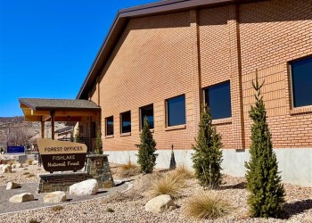 Side view of the Fishlake Supervisors office and Richfield Ranger District office building and Forest sign