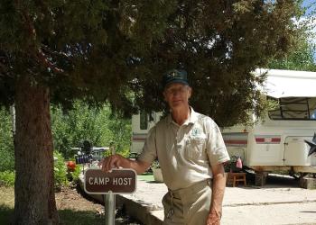 Terry Christensen shown next to the camp host sign at the Gooseberry Admin Site, at which he and his wife have been volunteers for seven seasons.