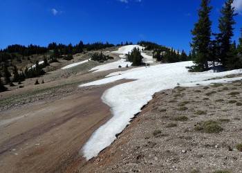 Forest Road 123 shows large snow drifts that have lasted into July, making the road impassable until it has melted