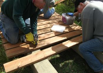 Volunteers helping the motorized trails crew restore the Anderson Dairy boardwalk on the Richfield Ranger District