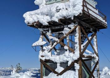 A fire lookout covered with snow and ice in the winter