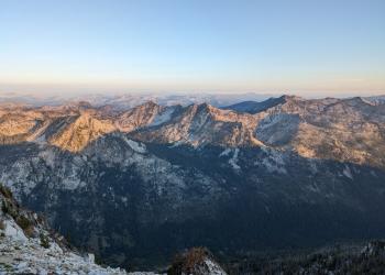 A rugged, granitic mountain range as seen from a high point.