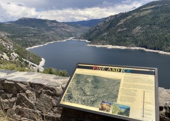 interpretive sign with hell hole reservoir in the background