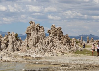 Hikers pass by uniquely shaped tufa tower formations by Mono Lake