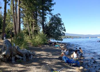 Visitors play along the rocky shoreline at Kaspian Beach on Lake Tahoe.