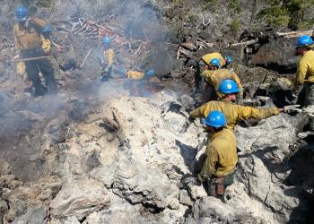 Lassen Hotshots on the H-1 Lightening caused Fire 2023. Firefighters moving through Lava Rock on the Hat Creek Ranger District, checking for hot spots and putting them out.