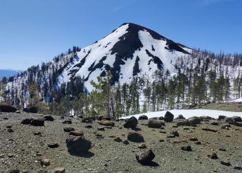Exposed and loose rocky peak blanketed in snow