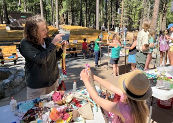Molly Rose helping young visitors make their own walking sticks!