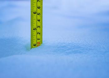 A measuring tape in the snow. 