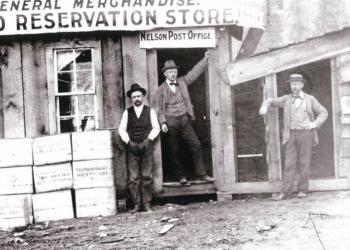 three men standing outside a general store