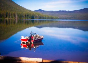 Fishing boat sits on lake 