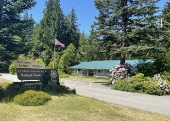 Ranger Station sign and American flag in front of the office.