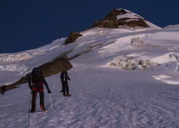 Two people participate in winter sports on mountain