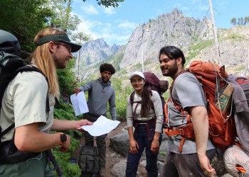Wilderness Ranger checking permits from a group of hikers in the Alpine Lakes Wilderness Area.