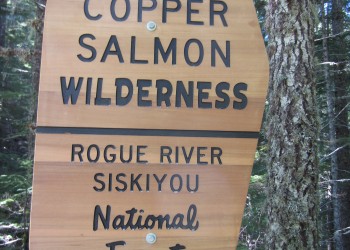 A wilderness sign reading Copper Salmon Wilderness Area Rogue River-Siskiyou National Forest